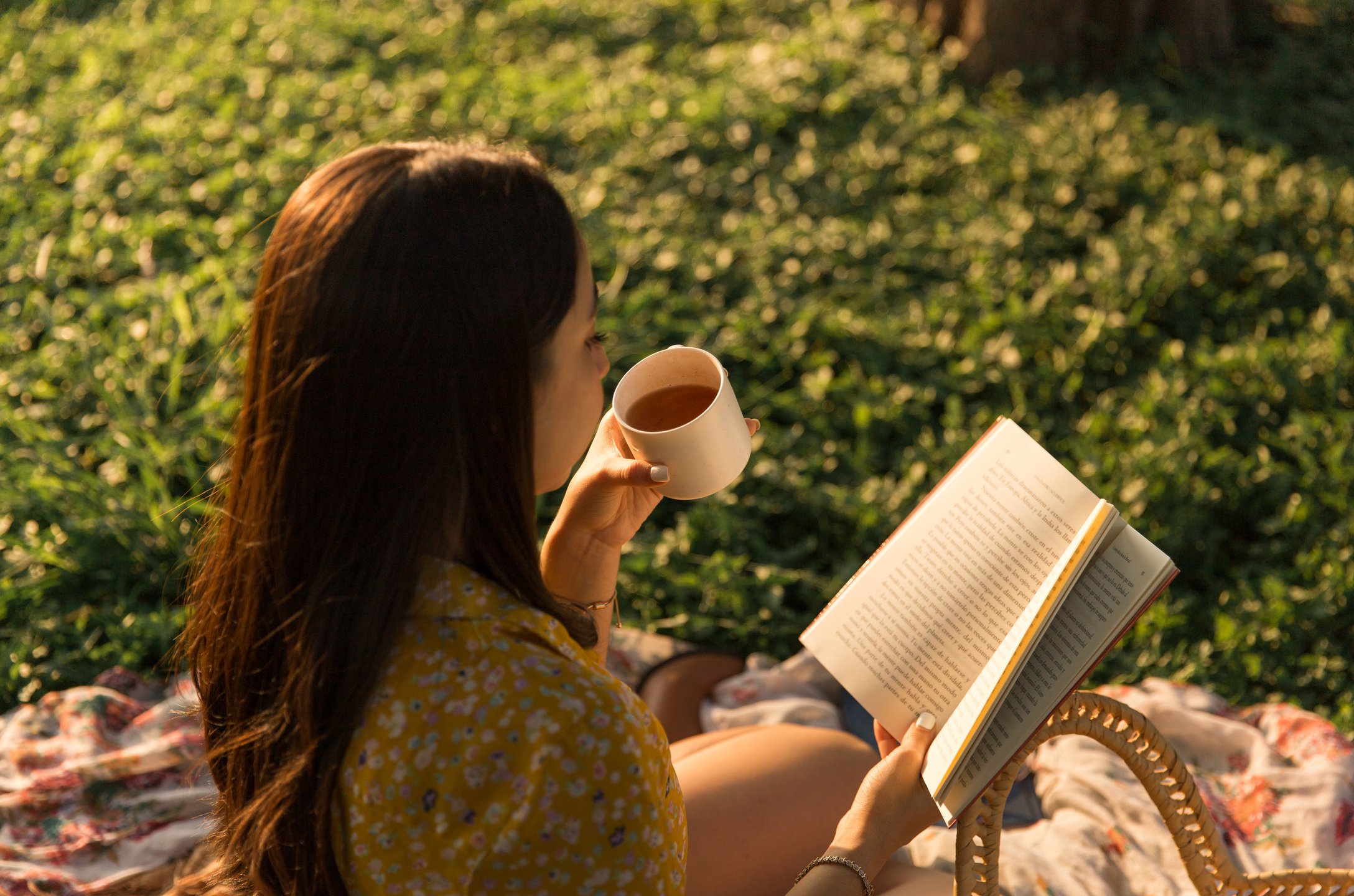 Woman Drinking  Tea and Reading Book High Angle Shot