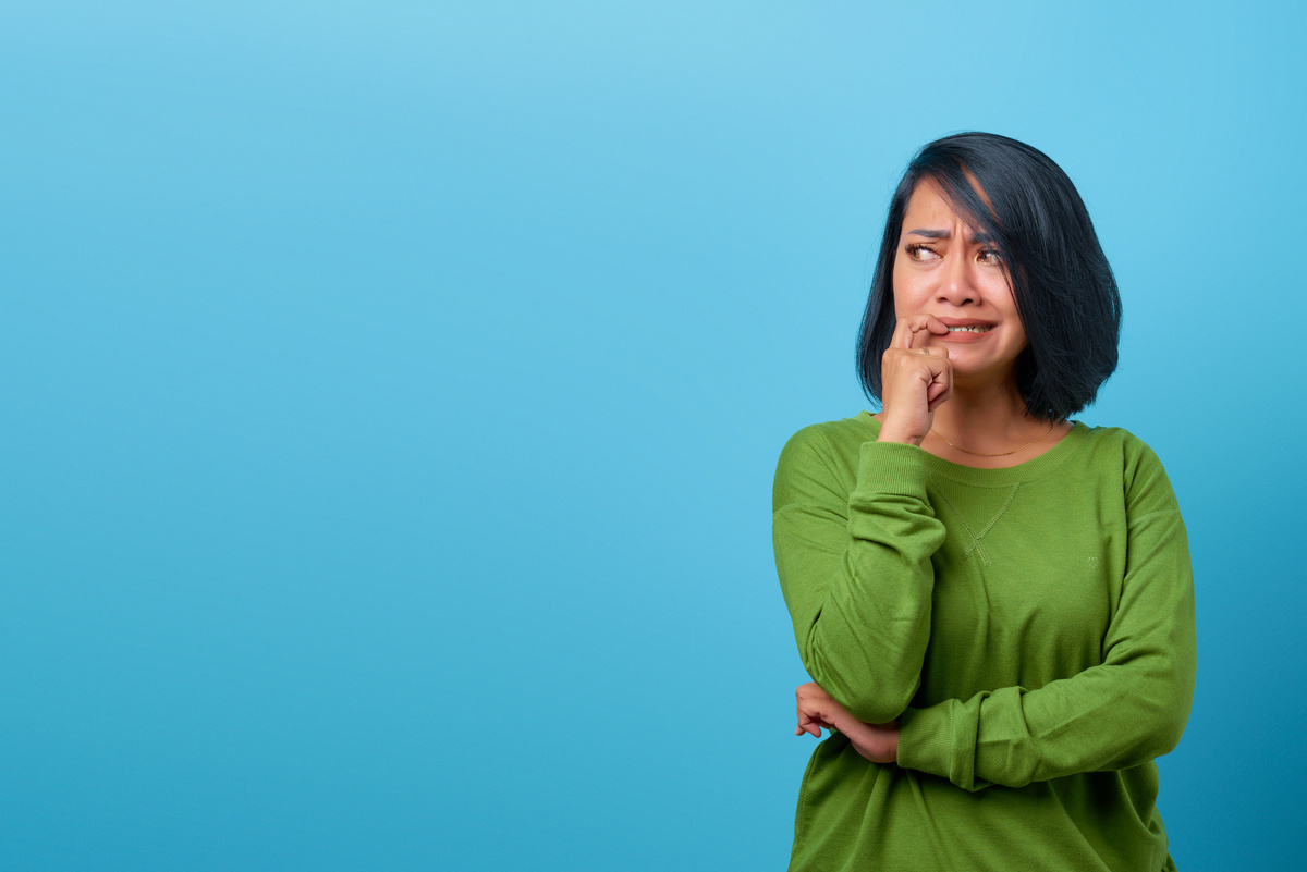 Attractive Asian Woman Looking Stressed and Nervous with Hand on